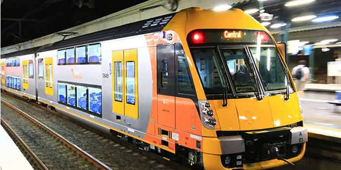 Double-deck passenger train at a station platform
